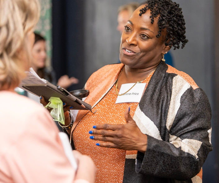 black woman in her 60s talking at secondactwomen event